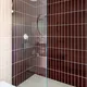2021 img hi res rights residential design handsome salt photo jenny siegwart bathroom floor tile 3x9 limestone glass shower backsplash 3x12 vertical straight set rosy finch pheasant gloss.jpg